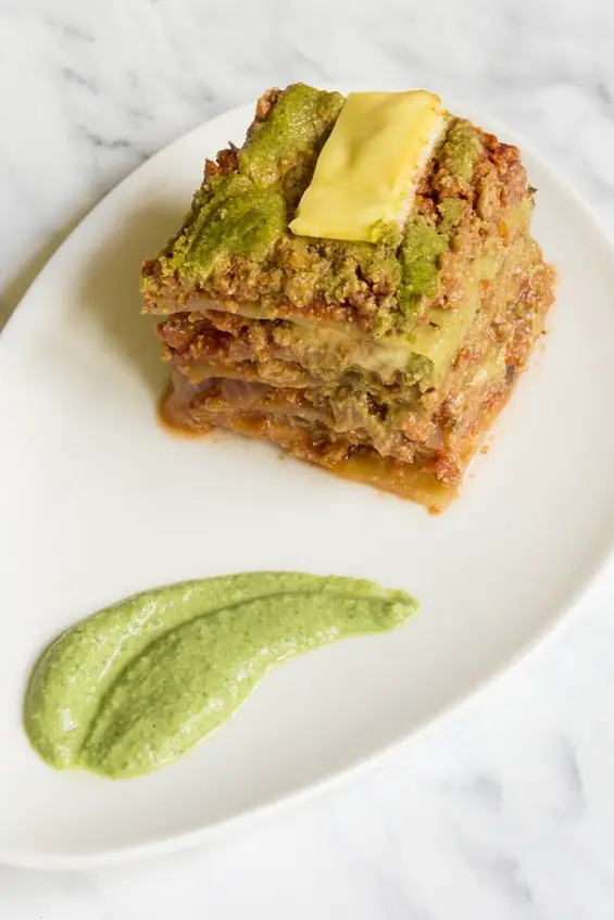 This is the best, naturally gluten-free, and vegan lasagna I have ever eaten. It is seriously bursting with flavor. Just imagine this: vegan ground beef cooked in hearty marinara sauce layered with spinach cashew alfredo sauce and sweet cabbage leaves. #veganlasagna #veganlasagne #lowcarb #vegan #glutenfree #cabbagelasagna. #cashewalfredo #marinarasauce #tvp #vegangroundbeef