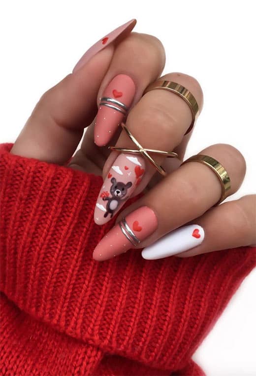 A soft little teddy bear is just lovely on V-Day, and you can draw it on all by yourself by creating small circles and lines. This cute nail design is extremely trendy for Valentine's day. 